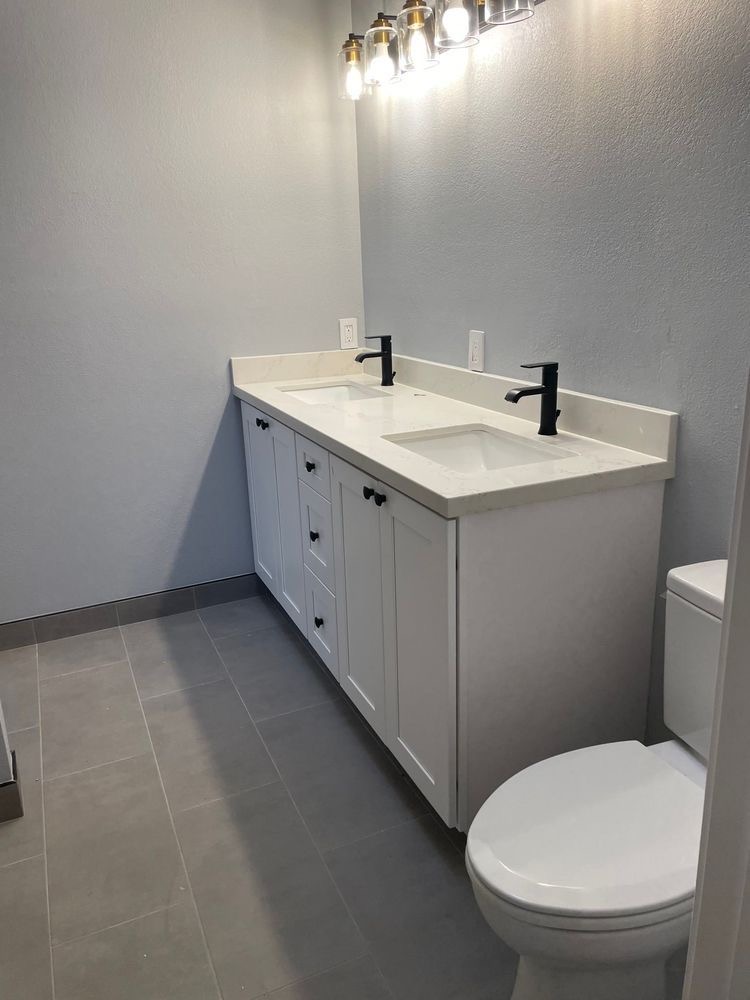 Finished bathroom with white double-sink vanity and matte black faucets